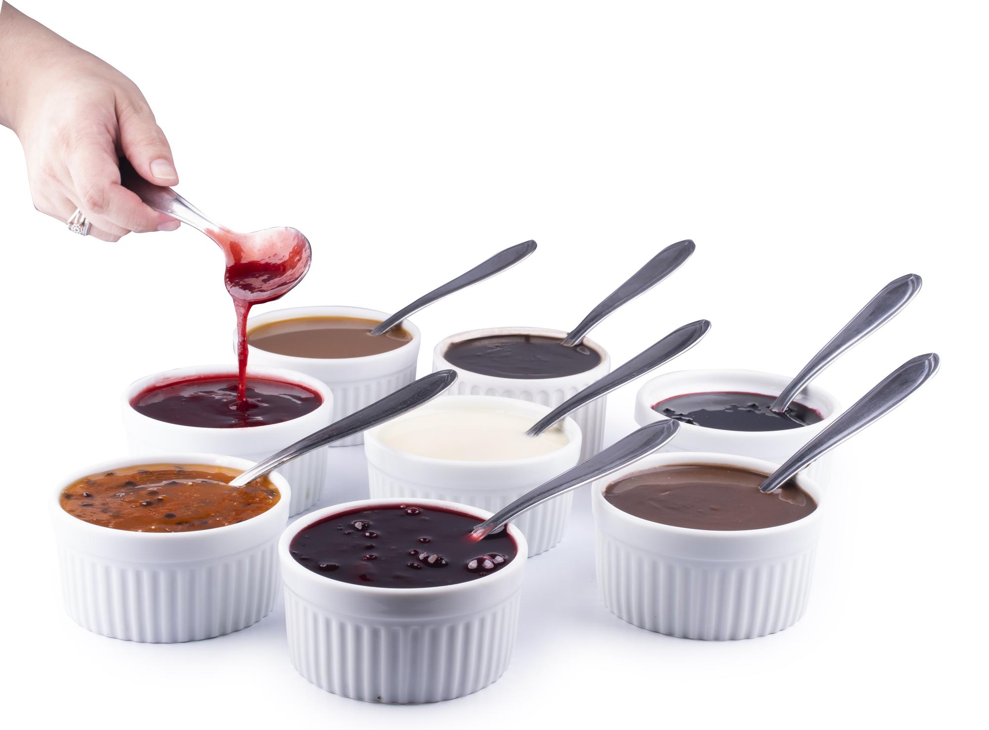 Chef testing sauces in bowls